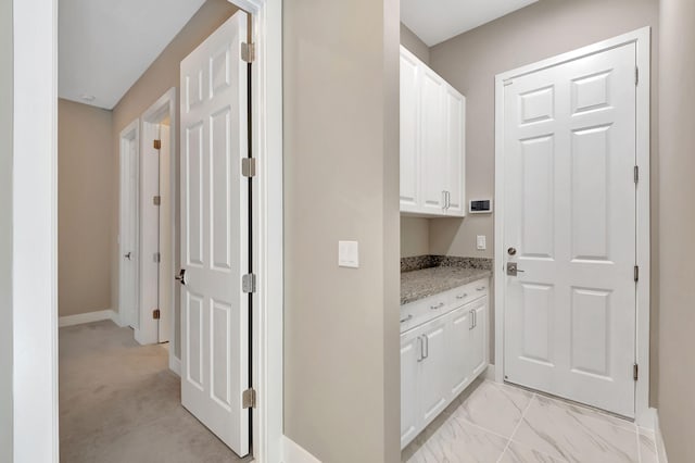 hall featuring light colored carpet