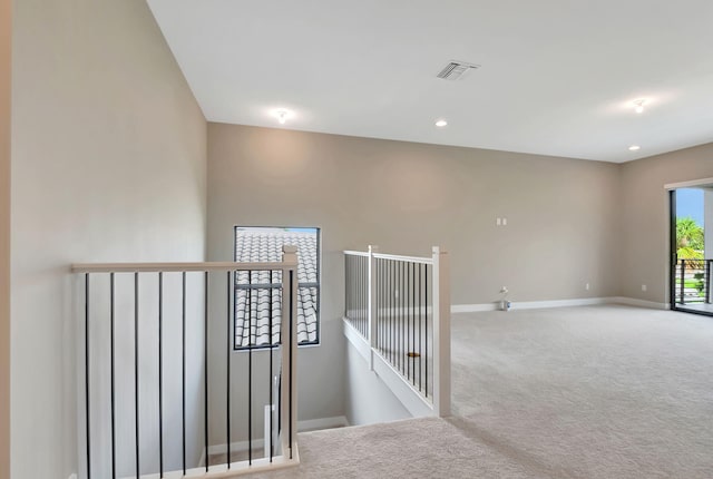 hallway with light colored carpet