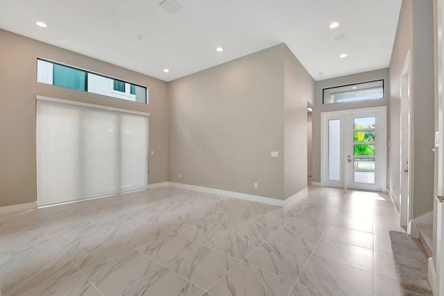 entryway with a towering ceiling