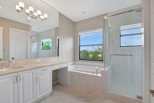 bathroom with vanity and shower with separate bathtub