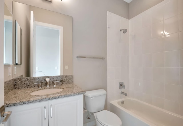 full bathroom with vanity, toilet, and tiled shower / bath combo