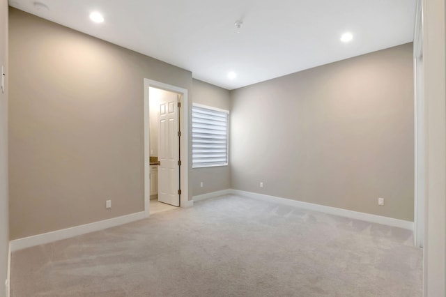 empty room featuring light carpet