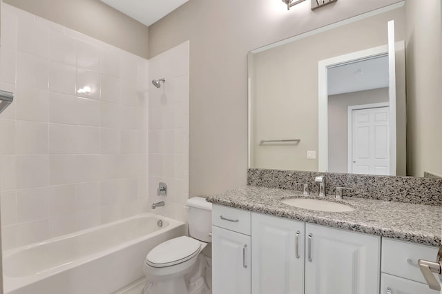 full bathroom featuring toilet, vanity, and tiled shower / bath combo