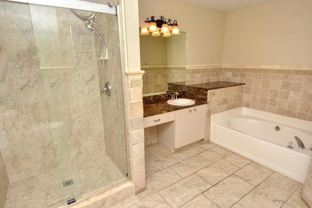 bathroom featuring vanity, tile walls, and plus walk in shower