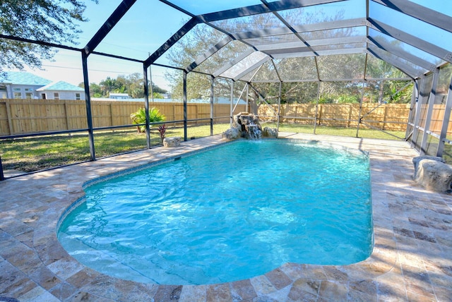 view of pool featuring pool water feature, a patio area, and a lanai