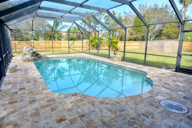 view of pool with a patio, a lanai, and a lawn