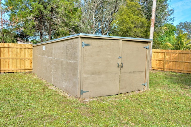 view of outbuilding with a yard