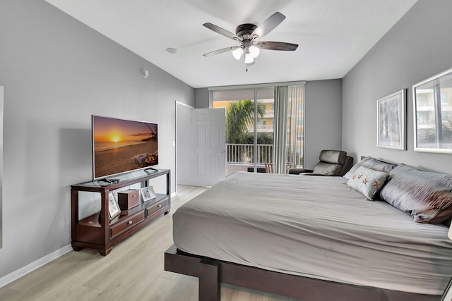 bedroom with ceiling fan, light hardwood / wood-style floors, and access to outside