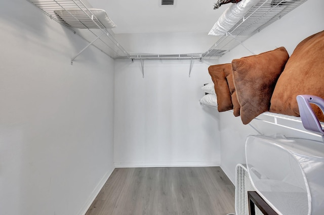 walk in closet featuring light hardwood / wood-style floors