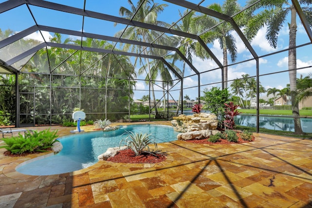 view of swimming pool with a patio, a water view, pool water feature, and a lanai