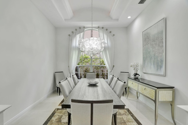 dining room with a tray ceiling and an inviting chandelier