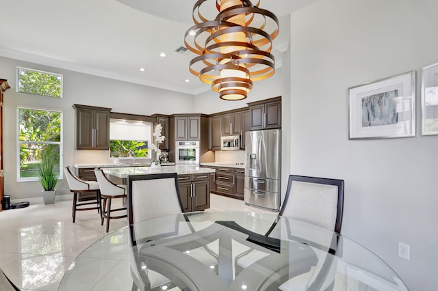 dining area featuring ornamental molding and a chandelier