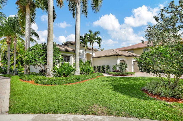 mediterranean / spanish house with a front yard