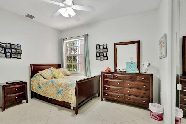 bedroom with ceiling fan and light tile patterned floors