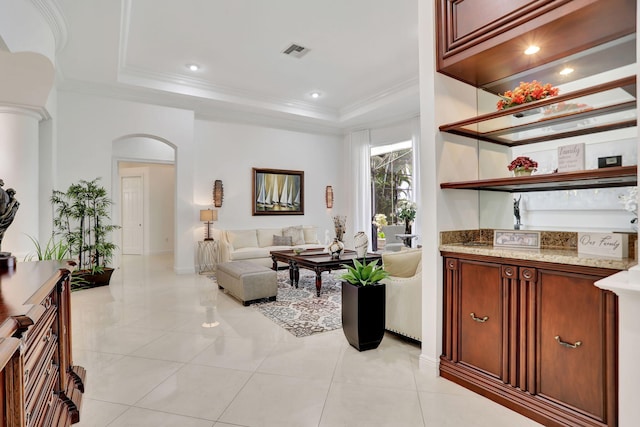 interior space featuring a tray ceiling and ornamental molding