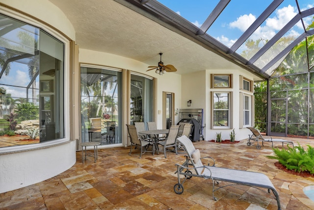 view of patio featuring ceiling fan, a lanai, and a grill