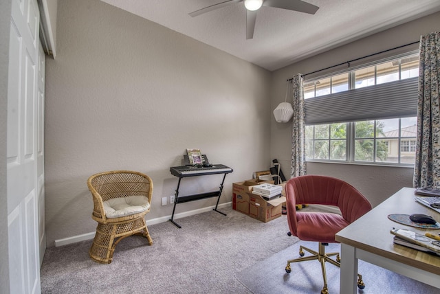 carpeted office space with a textured ceiling and ceiling fan