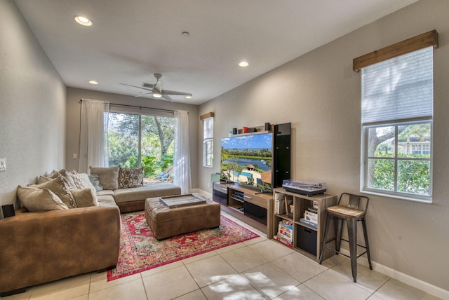 living room featuring ceiling fan and light tile patterned floors