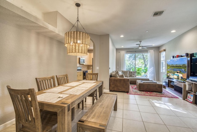 tiled dining area with ceiling fan