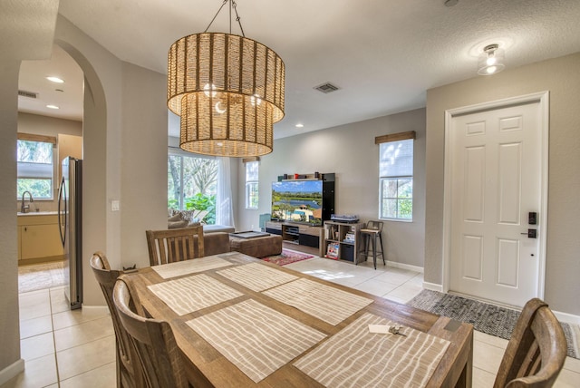 dining area featuring light tile patterned floors and sink