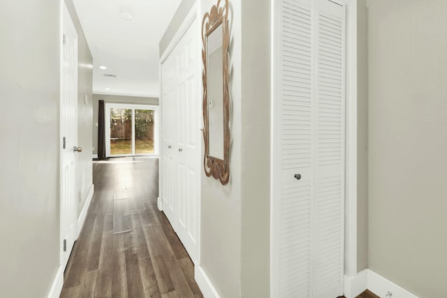 hallway with dark hardwood / wood-style floors