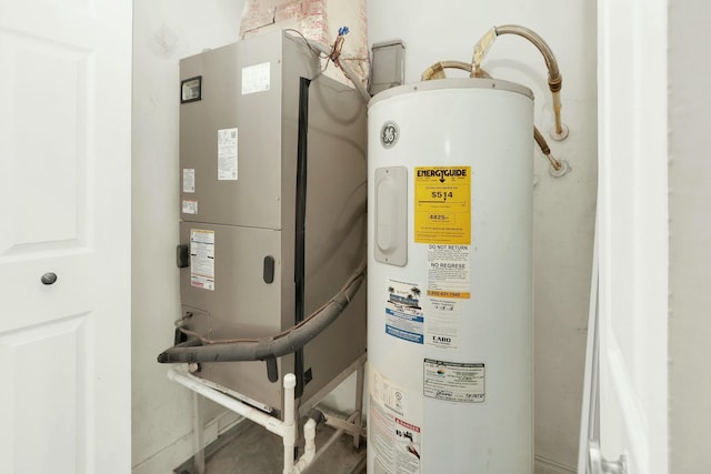 utility room with heating unit and electric water heater