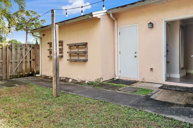 doorway to property featuring a yard