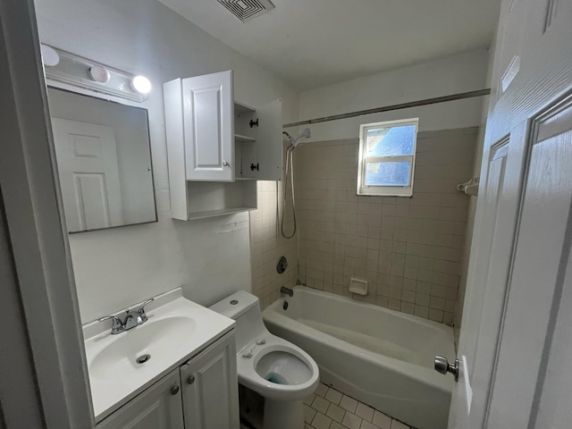 full bathroom featuring vanity, tiled shower / bath combo, tile patterned floors, and toilet