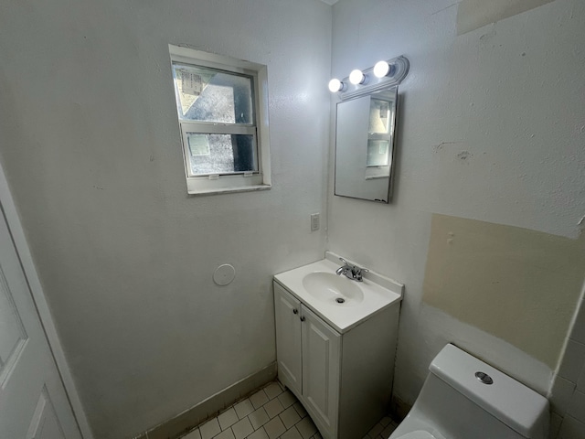 bathroom with tile patterned flooring, vanity, and toilet