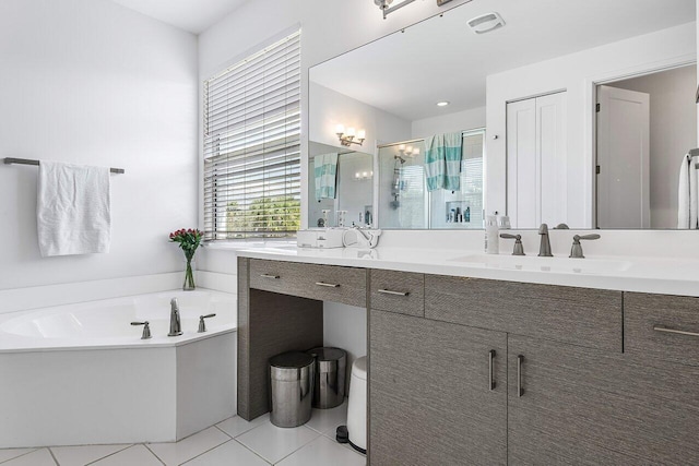 bathroom with tile patterned flooring, separate shower and tub, and vanity