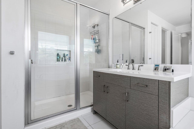 bathroom with vanity, tile patterned flooring, and a shower with door