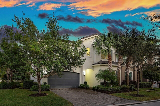 15360 Seaglass Terrace Ln, Delray Beach, FL 33446 - view of front of home featuring driveway, stucco siding, a tiled roof, a yard, and an attached garage