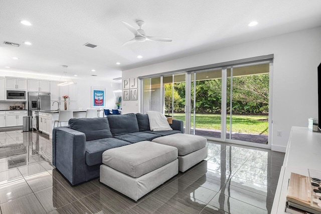 15360 Seaglass Terrace Ln, Delray Beach, FL 33446 - living area with ceiling fan, recessed lighting, a textured ceiling, and tile patterned floors