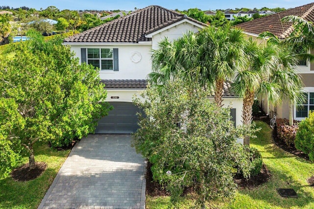 mediterranean / spanish-style house with a garage