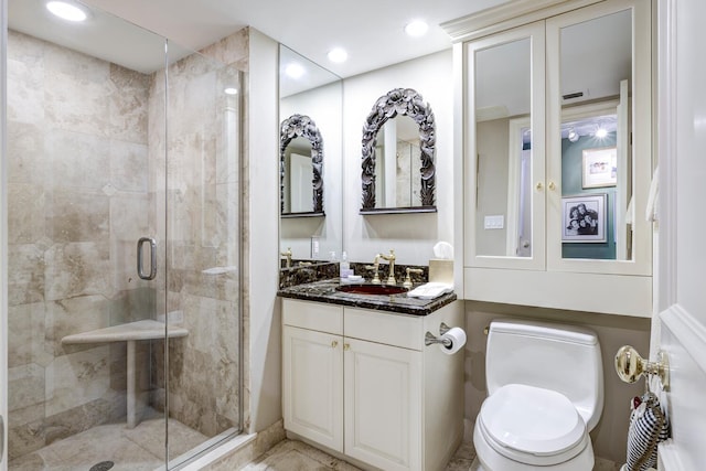 bathroom with vanity, an enclosed shower, and toilet