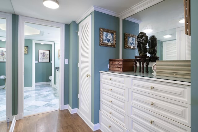 corridor featuring wood-type flooring and crown molding