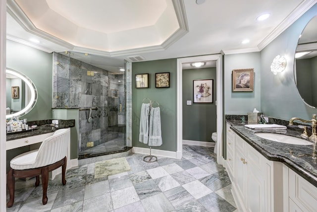 bathroom with toilet, a tray ceiling, a shower with door, vanity, and ornamental molding