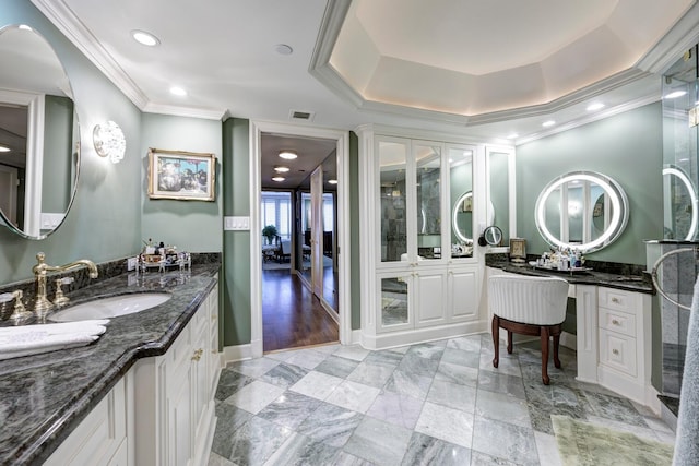 bathroom featuring vanity, crown molding, and a tray ceiling