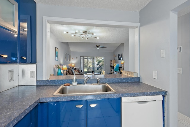 kitchen with lofted ceiling, white dishwasher, blue cabinets, sink, and a textured ceiling