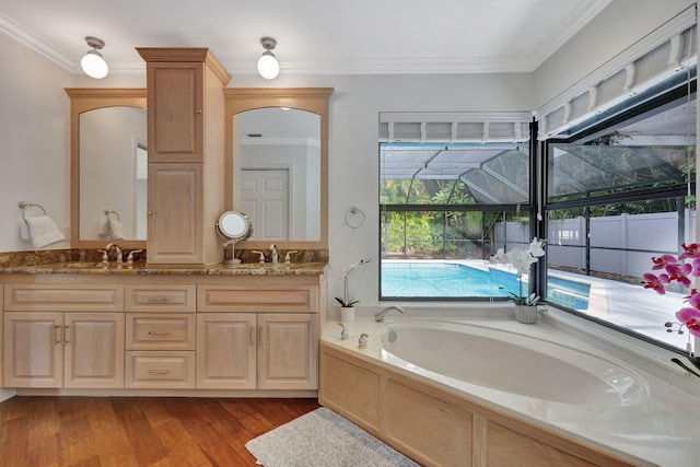 bathroom featuring crown molding, hardwood / wood-style floors, and vanity