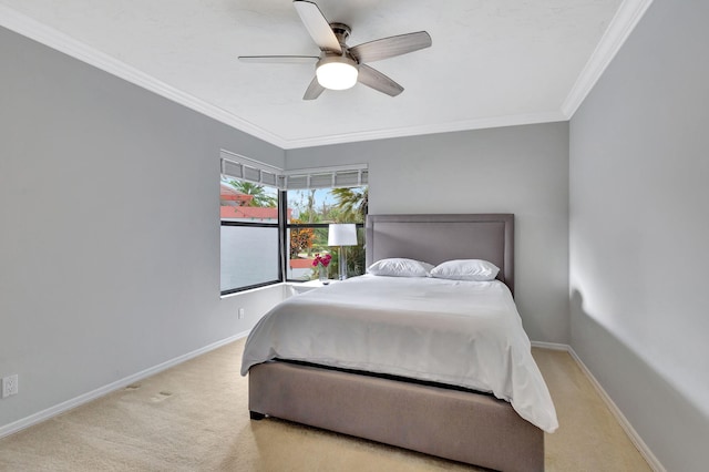 bedroom featuring light colored carpet, ceiling fan, and crown molding