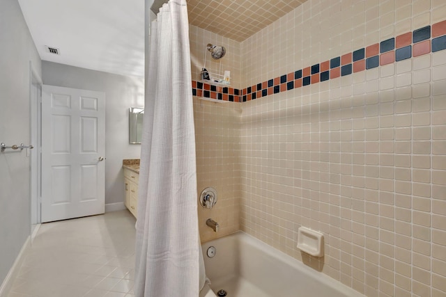 bathroom featuring tile patterned floors, vanity, and shower / bathtub combination with curtain