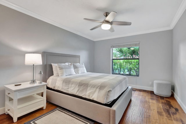 bedroom featuring dark hardwood / wood-style floors, ceiling fan, and ornamental molding