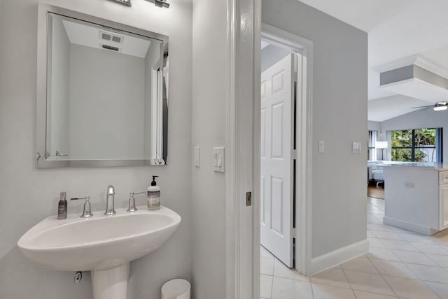 bathroom featuring tile patterned floors, ceiling fan, lofted ceiling, and sink