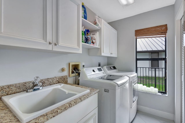 laundry area featuring sink, light tile patterned flooring, cabinets, and independent washer and dryer