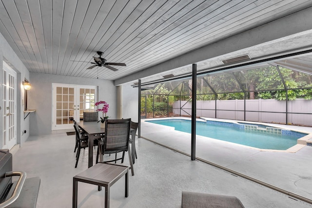 view of pool featuring ceiling fan and french doors