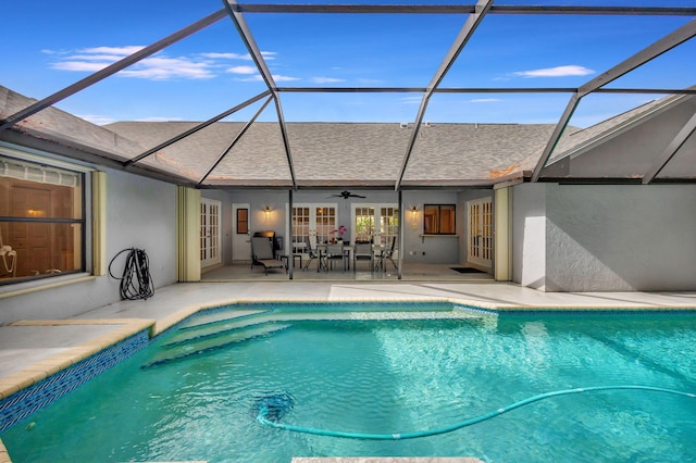 view of swimming pool with french doors, a patio area, ceiling fan, and a lanai