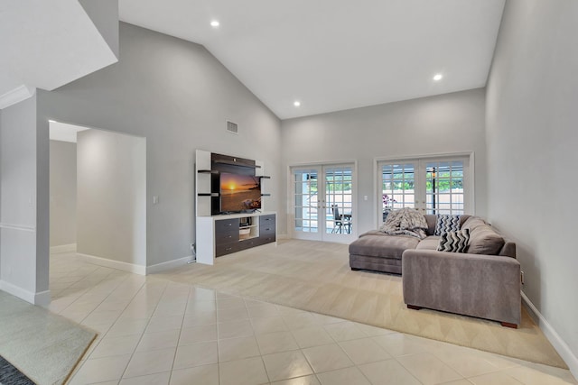 living room featuring light tile patterned floors, high vaulted ceiling, and french doors