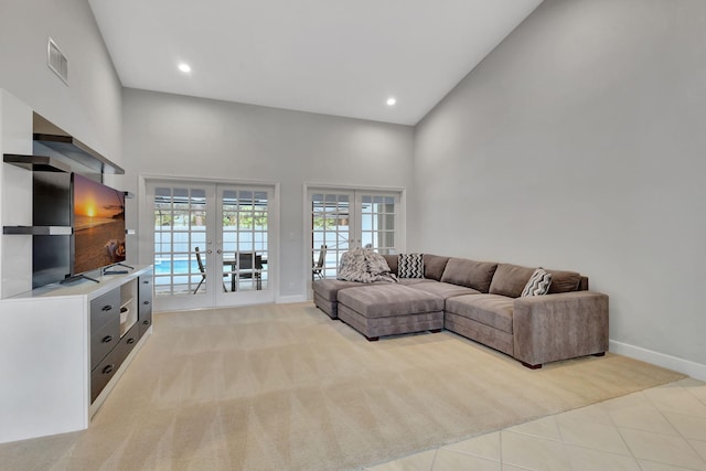 living room featuring light tile patterned flooring, high vaulted ceiling, and french doors