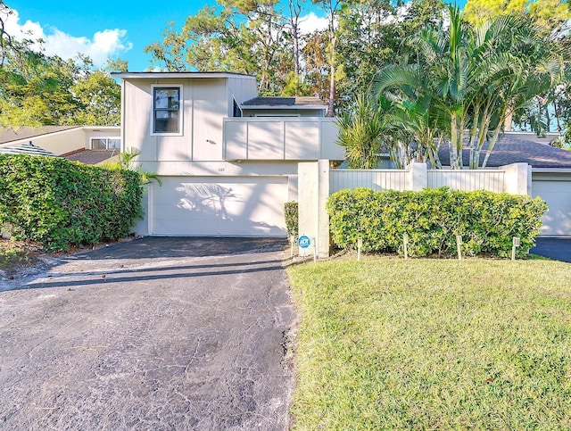 view of front of property with a garage and a front lawn